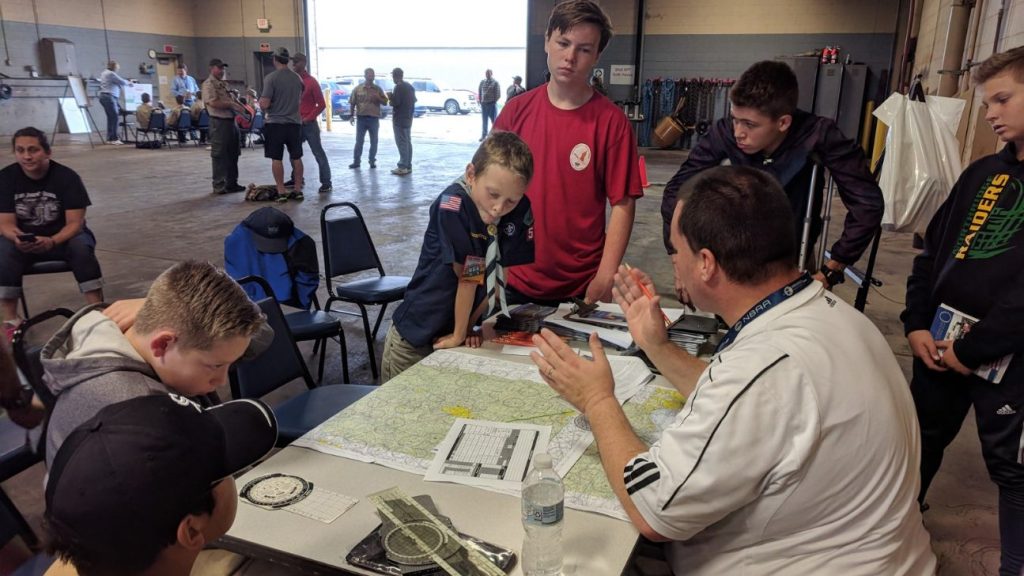 Airport tenant and boy scout looking at a map