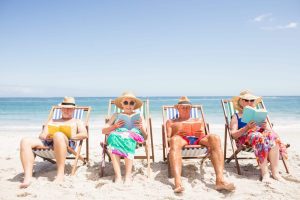 senior adults reading books on the beach travel gift ideas